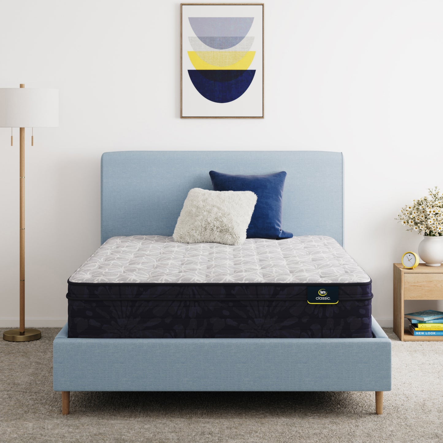 Serta Classic Clarks Hill 12.5" mattress sitting in a blue bed frame with 2 pillows on top of it.